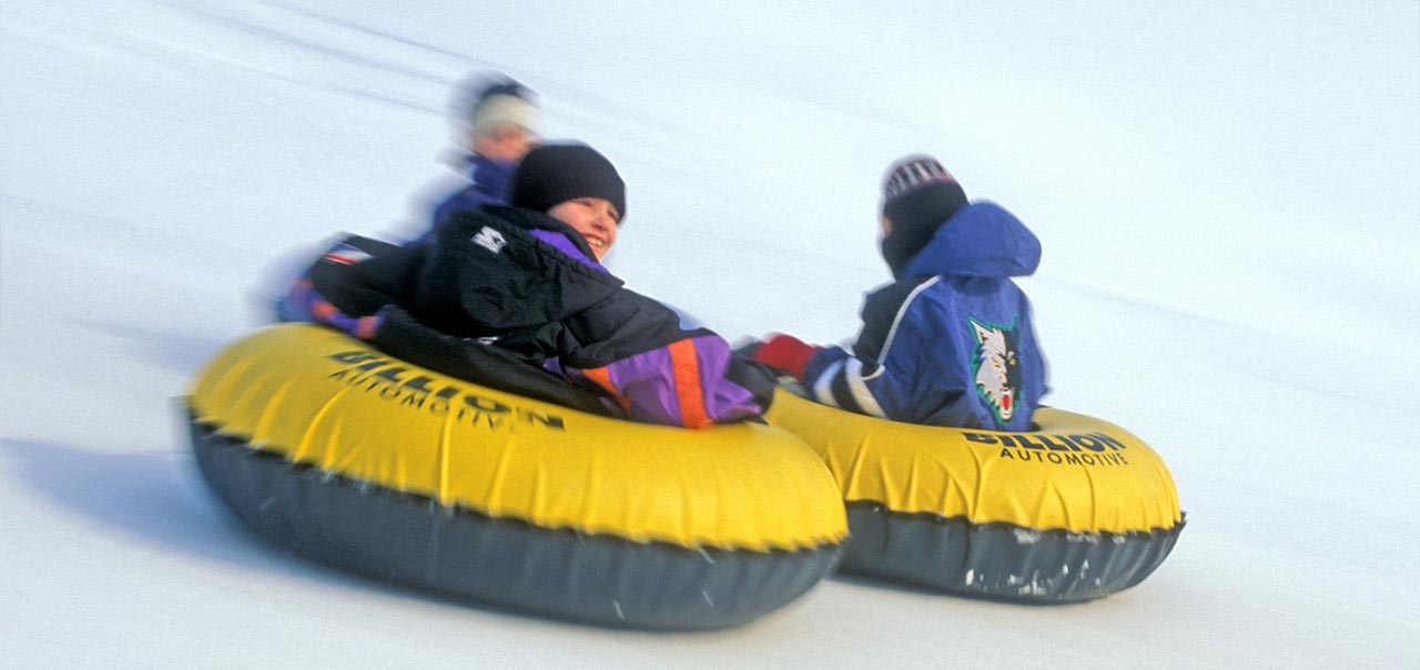 A group of kids out sledding. 