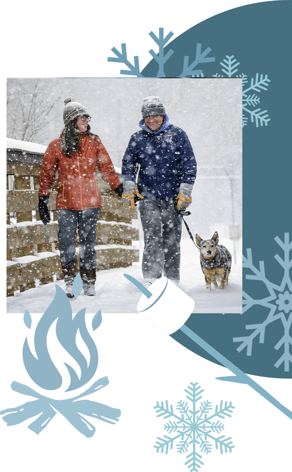 A couple out walking their dog in the snow.