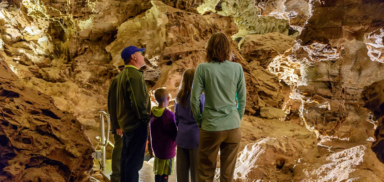 A family exploring a cave.