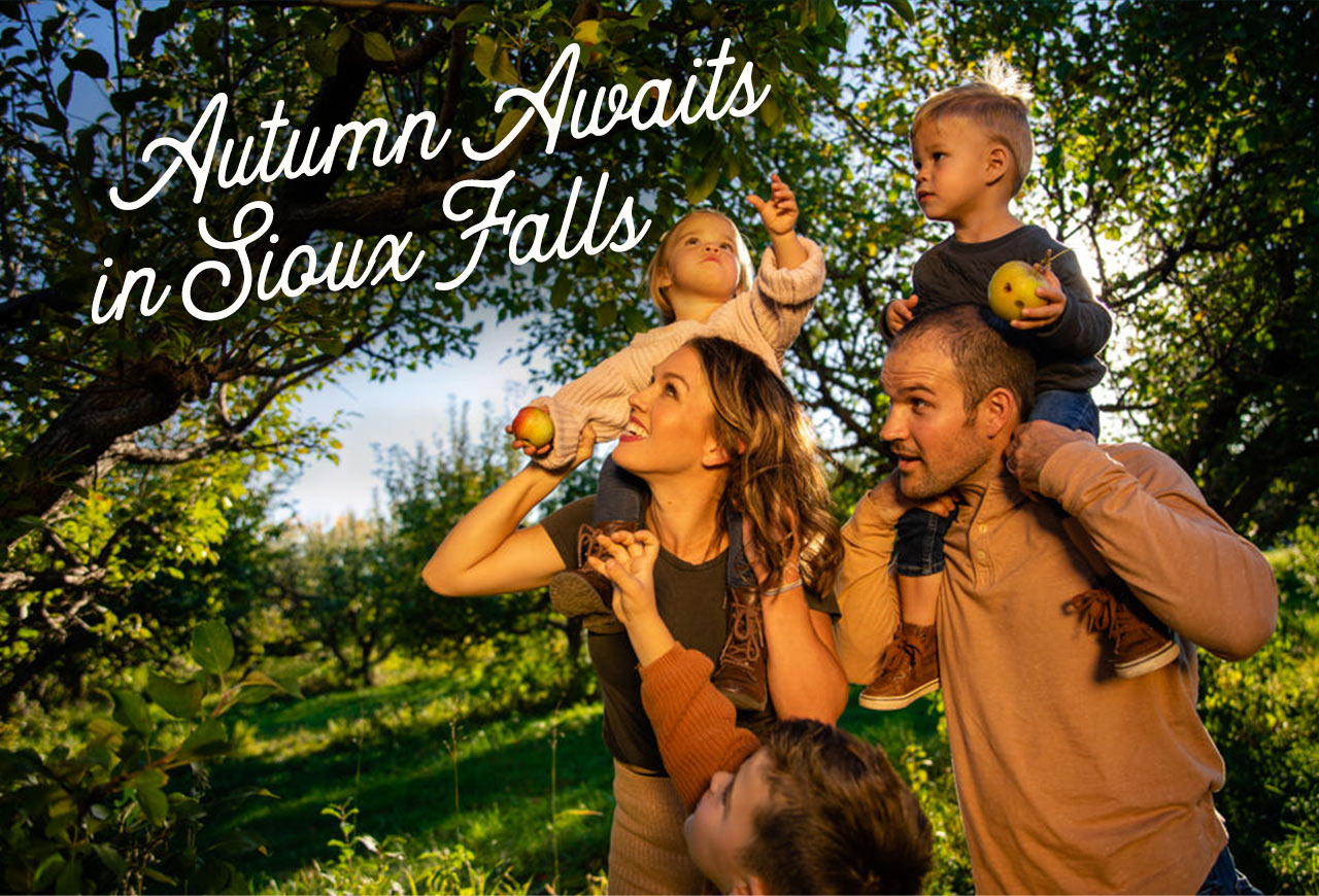 A family walks through an apple orchard, picking apples. A headline reads: Autumn awaits in Sioux Falls
