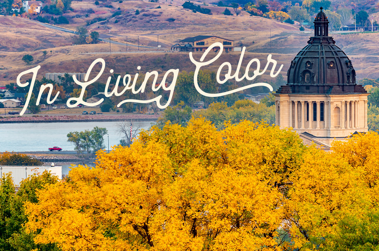 The South Dakota capital building surrounded by fall foliage. A headline reads: In Living Color