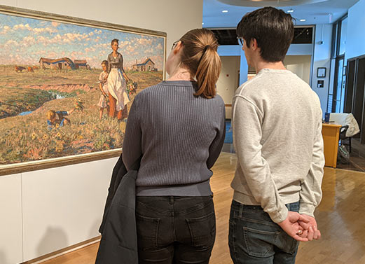 A couple enjoying an art gallery.