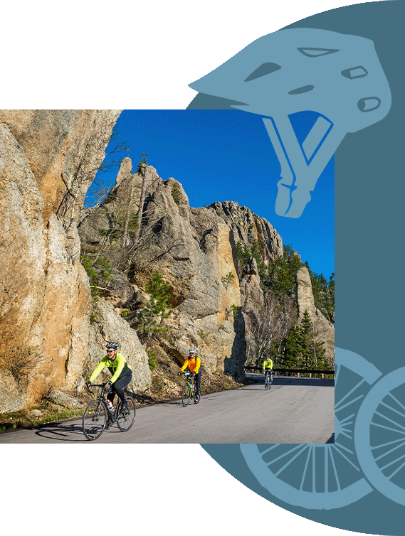 A group biking near cliffs.