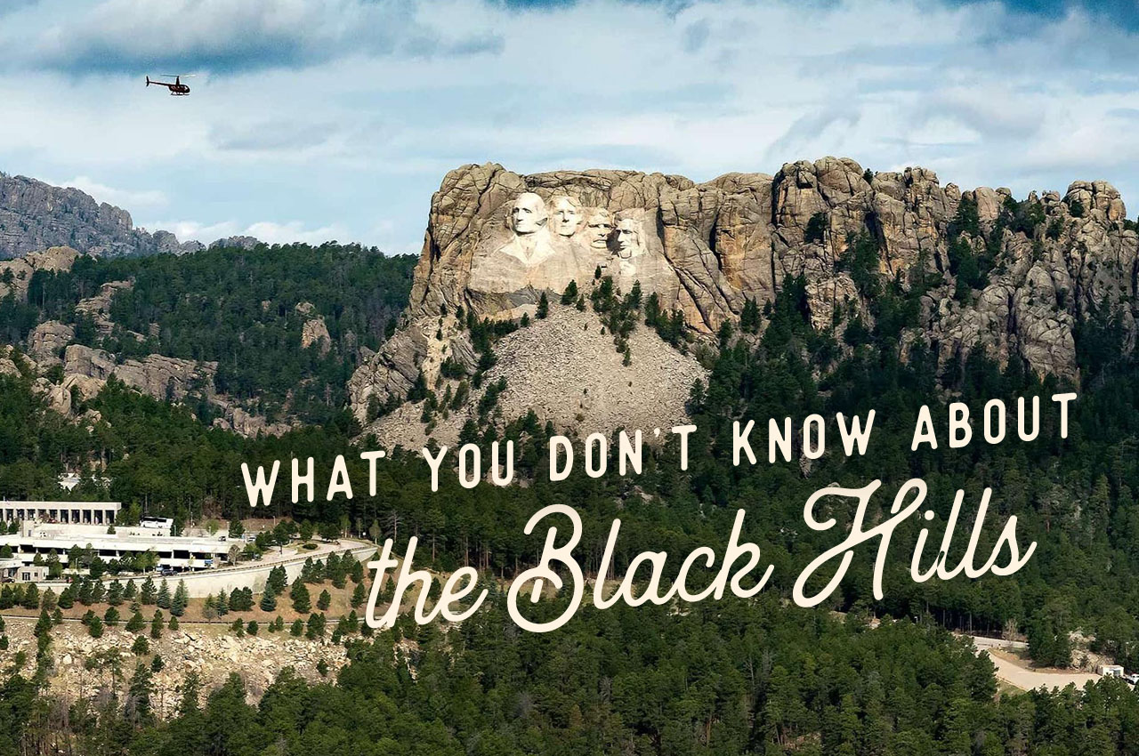 An aerial view of Mt. Rushmore and the surrounding area. A headline reads: What You Don't Know About The Black Hills