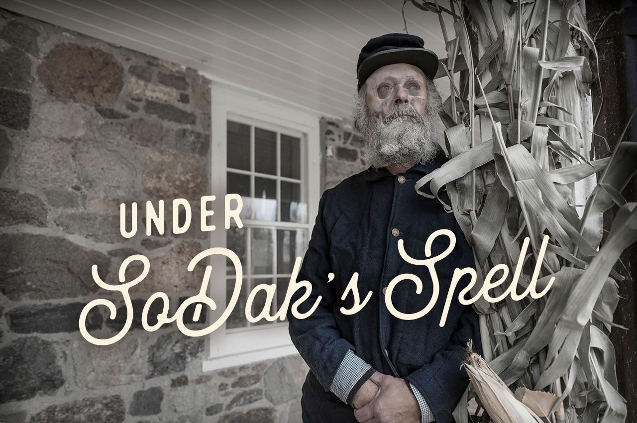 A ghostly, skeletal Old West figure stands in front of an historic building. A headline reads: Under SoDak's Spell
