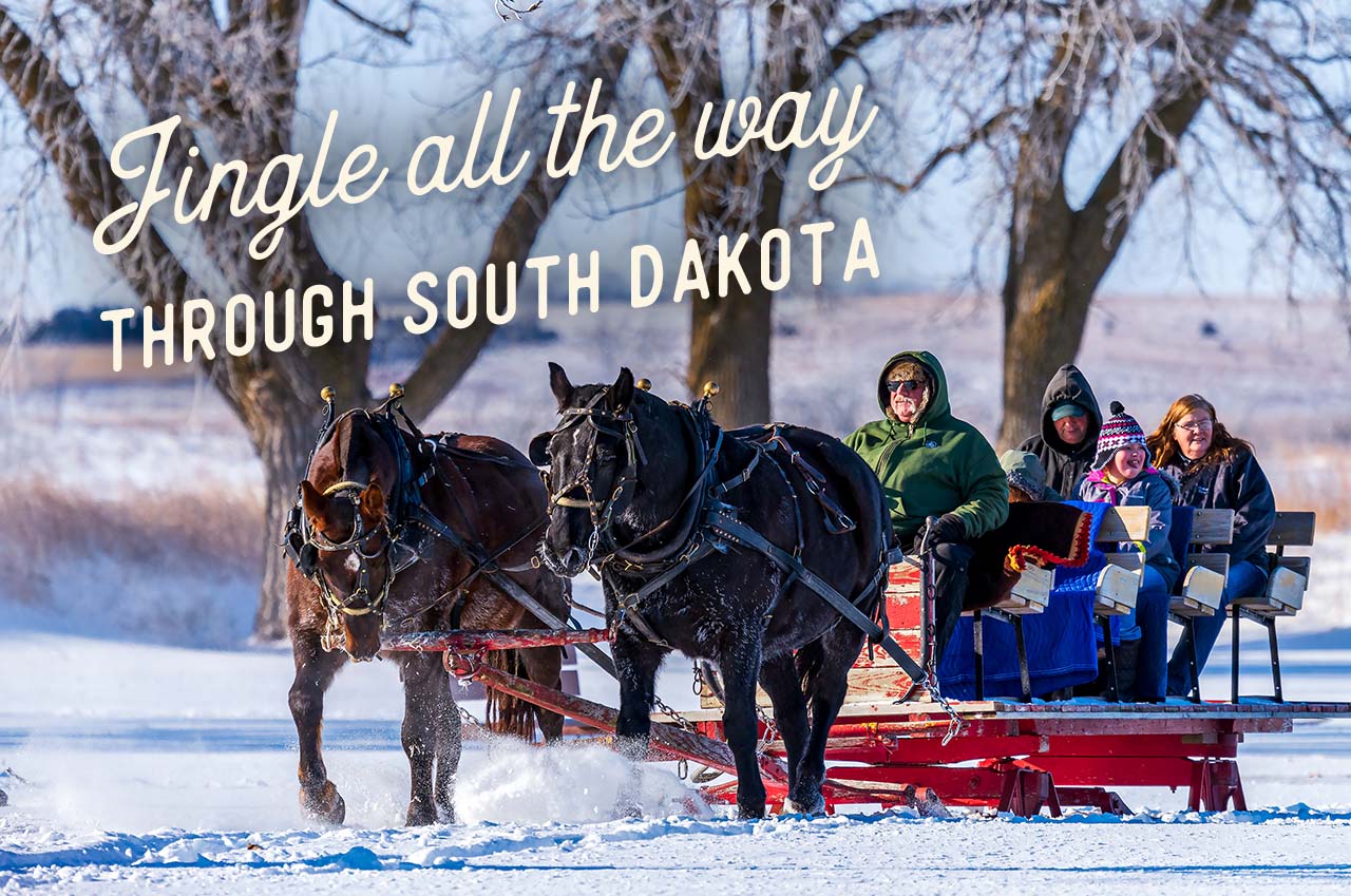 A family being pulled in a horse-drawn sled through snow. A headline reads: Jingle all the way through South Dakota