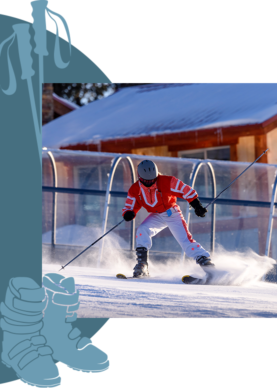 A skier throwing up snow as he slides to a stop at the end of a slope.