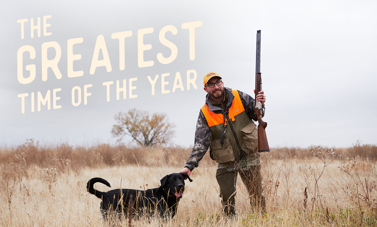 A man and his dog out hunting in a field. A headline reads: The Greatest Time of the Year
